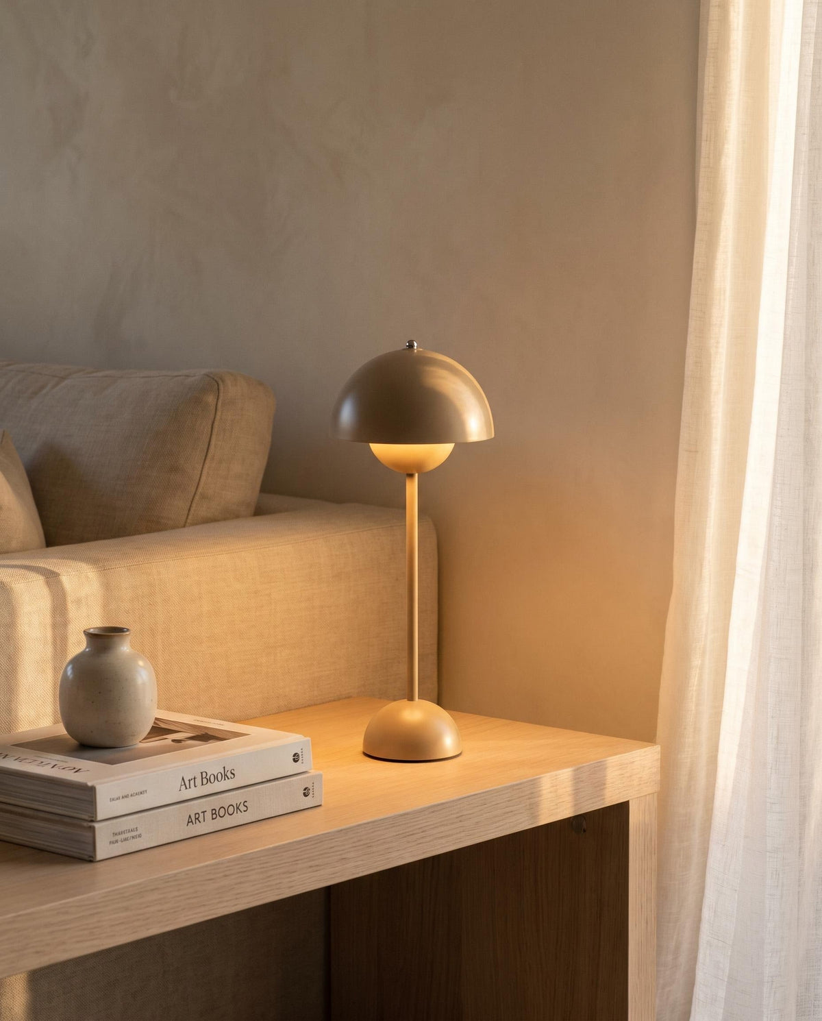 Cordless Las Noche table lamp glowing on an oak console beside a linen sofa