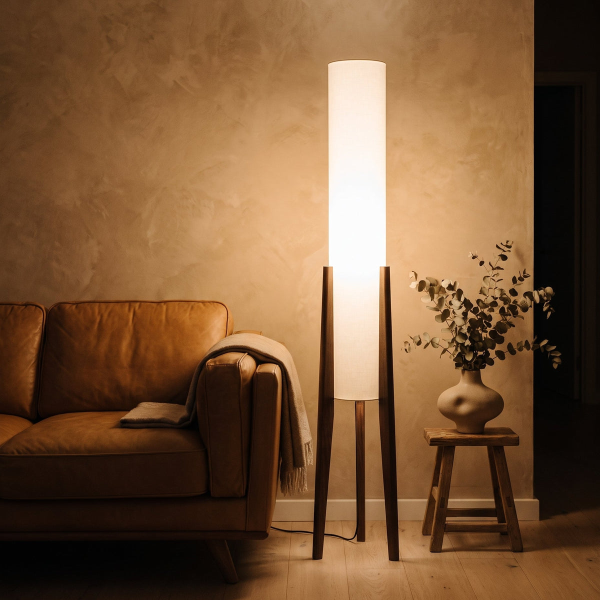 Cirio Walnut Column Floor Lamp beside a leather sofa