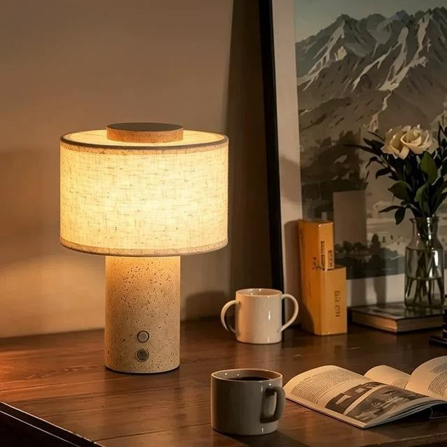Duna cordless lamp with linen drum shade glowing on a sideboard in the evening
